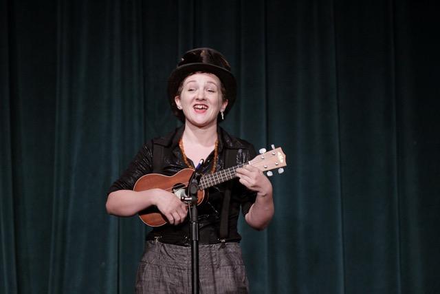 Millie Van Illa singing a song while hosting October 2016